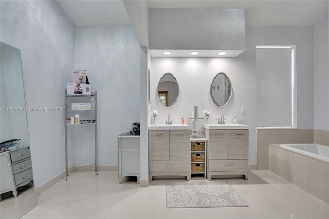 5347 SW 32nd Ter, Hollywood, FL 33312 - bathroom featuring two vanities, a garden tub, and tile patterned floors