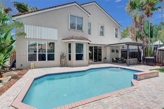 5347 SW 32nd Ter, Hollywood, FL 33312 - back of property with stucco siding, outdoor lounge area, a patio area, and a tile roof