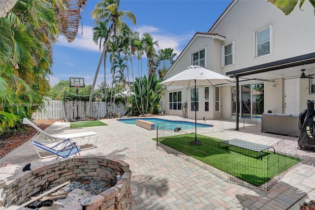 5347 SW 32nd Ter, Hollywood, FL 33312 - view of swimming pool featuring an outdoor fire pit, a patio area, a fenced backyard, and a ceiling fan