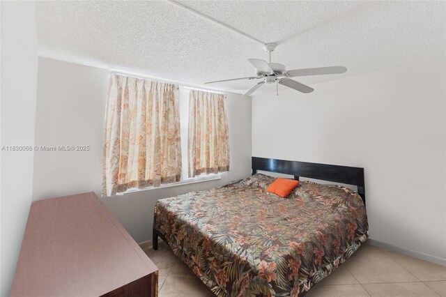 7690 NW 18th St Unit 408, Margate, FL 33063 - bedroom with tile patterned flooring, a textured ceiling, and a ceiling fan