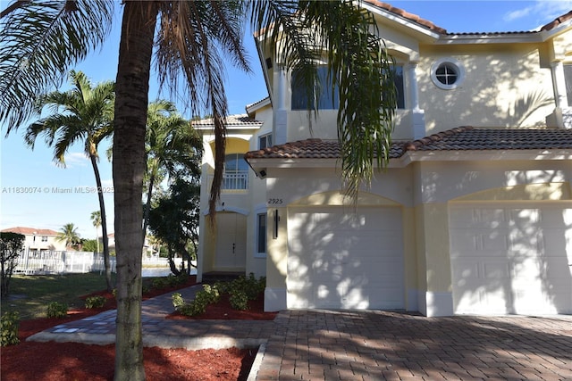 2925 SW 133rd Ave, Miramar, FL 33027 - mediterranean / spanish-style home featuring a tiled roof, stucco siding, an attached garage, and decorative driveway