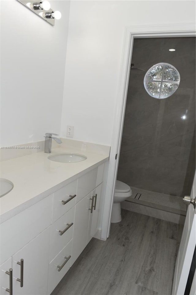 2925 SW 133rd Ave, Miramar, FL 33027 - bathroom featuring wood finished floors, double vanity, and a shower
