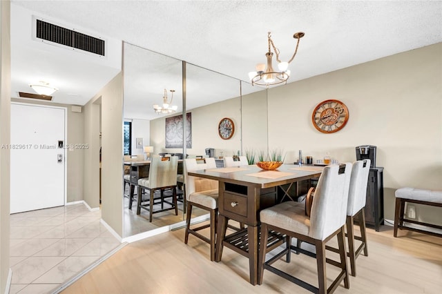 500 Three Islands Blvd Unit 320, Hallandale Beach, FL 33009 - dining space featuring a chandelier and baseboards
