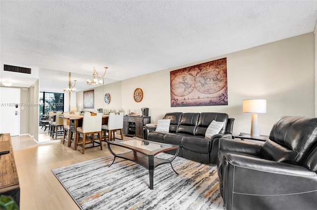 500 Three Islands Blvd Unit 320, Hallandale Beach, FL 33009 - living area with a chandelier, wood finished floors, and a textured ceiling
