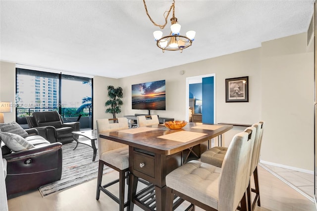 500 Three Islands Blvd Unit 320, Hallandale Beach, FL 33009 - dining space featuring a chandelier, a textured ceiling, and floor to ceiling windows