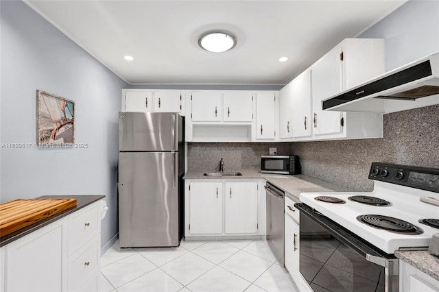 500 Three Islands Blvd Unit 320, Hallandale Beach, FL 33009 - kitchen with stainless steel appliances, wall chimney exhaust hood, backsplash, white cabinets, and light countertops