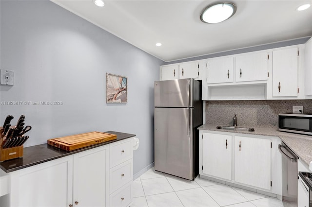 500 Three Islands Blvd Unit 320, Hallandale Beach, FL 33009 - kitchen featuring appliances with stainless steel finishes, white cabinetry, backsplash, recessed lighting, and light tile patterned floors