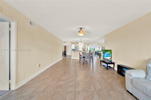 10217 NW 24th Pl Unit 310, Sunrise, FL 33322 - living room featuring baseboards and a chandelier