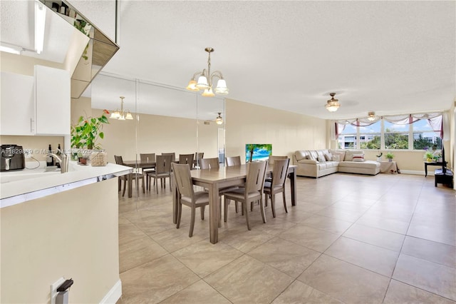 10217 NW 24th Pl Unit 310, Sunrise, FL 33322 - dining area featuring a chandelier, ceiling fan, light tile patterned floors, and a textured ceiling