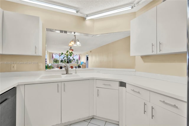 10217 NW 24th Pl Unit 310, Sunrise, FL 33322 - kitchen with dishwasher, light countertops, white cabinets, light tile patterned floors, and a textured ceiling
