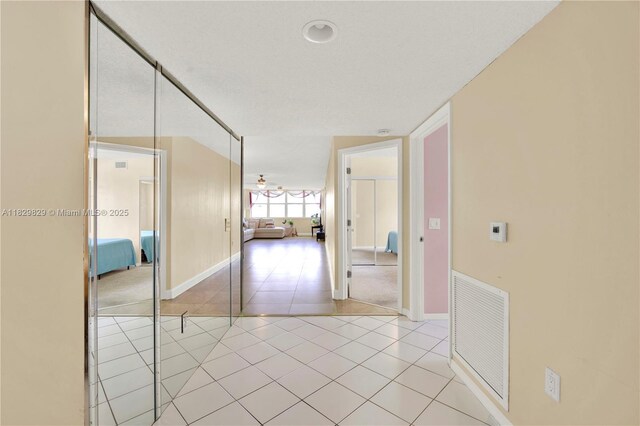 10217 NW 24th Pl Unit 310, Sunrise, FL 33322 - hallway with light tile patterned flooring and baseboards