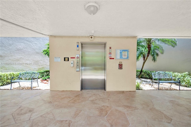 10217 NW 24th Pl Unit 310, Sunrise, FL 33322 - doorway to property featuring elevator and stucco siding