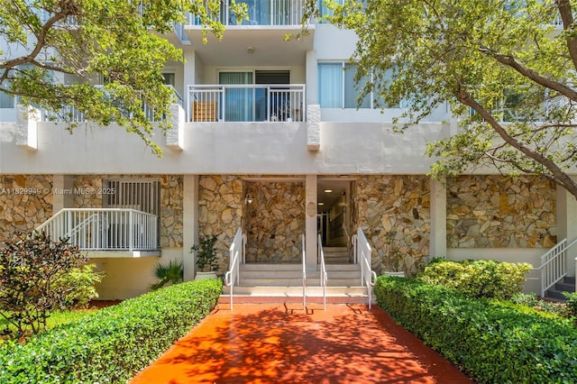 1345 Lincoln Rd Unit 1005, Miami Beach, FL 33139 - view of front facade with stone siding, a balcony, and stucco siding