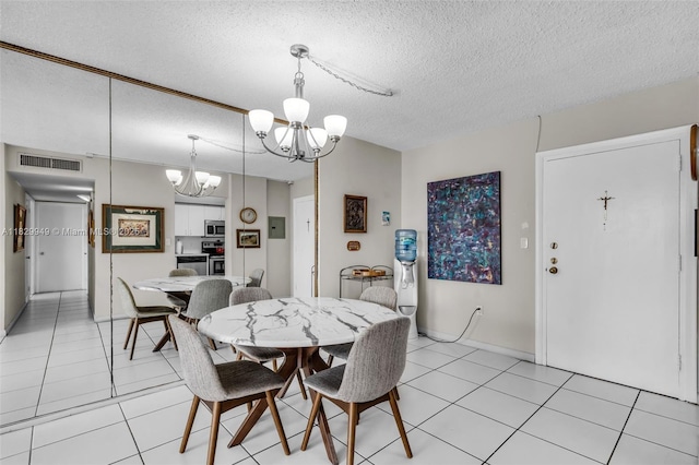 1345 Lincoln Rd Unit 1005, Miami Beach, FL 33139 - dining area featuring a chandelier, a textured ceiling, and light tile patterned flooring