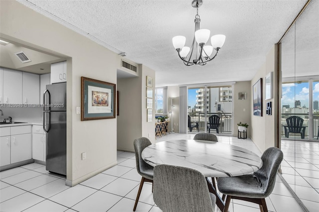 1345 Lincoln Rd Unit 1005, Miami Beach, FL 33139 - dining area with a textured ceiling, a chandelier, and light tile patterned flooring
