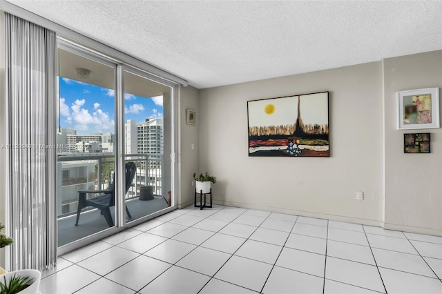 1345 Lincoln Rd Unit 1005, Miami Beach, FL 33139 - empty room with a textured ceiling, a wall of windows, a city view, and tile patterned floors