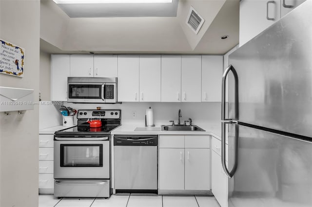 1345 Lincoln Rd Unit 1005, Miami Beach, FL 33139 - kitchen featuring stainless steel appliances, light countertops, white cabinets, and light tile patterned flooring
