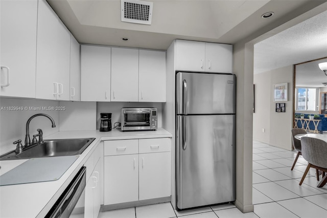 1345 Lincoln Rd Unit 1005, Miami Beach, FL 33139 - kitchen with appliances with stainless steel finishes, light countertops, white cabinetry, and light tile patterned floors
