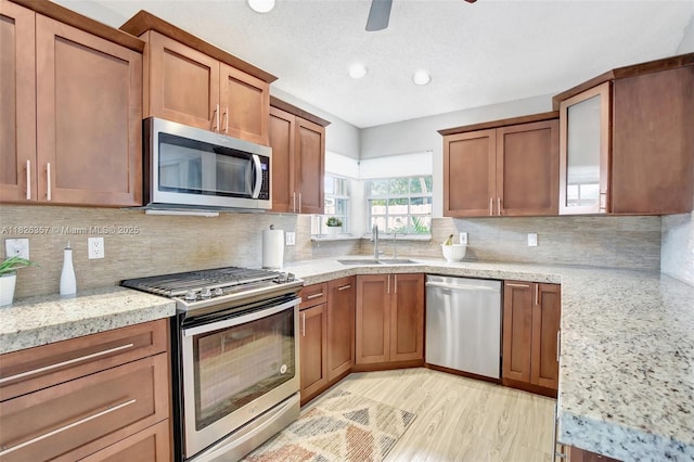 13552 NW 5th Ct, Plantation, FL 33325 - kitchen with appliances with stainless steel finishes, light stone counters, brown cabinets, decorative backsplash, and recessed lighting