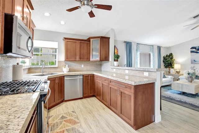 13552 NW 5th Ct, Plantation, FL 33325 - kitchen featuring appliances with stainless steel finishes, ceiling fan, brown cabinetry, light wood-type flooring, and recessed lighting