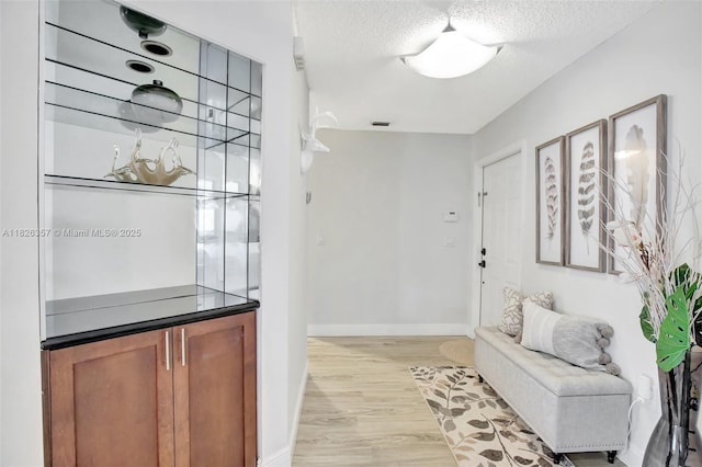 13552 NW 5th Ct, Plantation, FL 33325 - bar area with light wood-style flooring and a textured ceiling