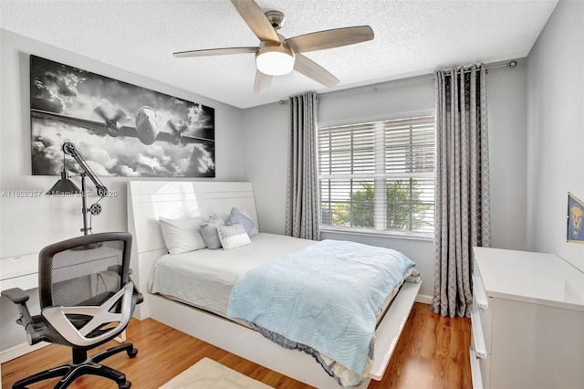 13552 NW 5th Ct, Plantation, FL 33325 - bedroom with a textured ceiling, wood finished floors, ceiling fan, and an office area