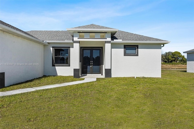 933 Gleason St, Lehigh Acres, FL 33974 - rear view of house with french doors, a shingled roof, a lawn, and stucco siding