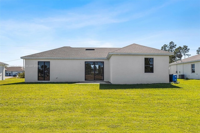 933 Gleason St, Lehigh Acres, FL 33974 - rear view of property featuring a yard, stucco siding, and roof with shingles