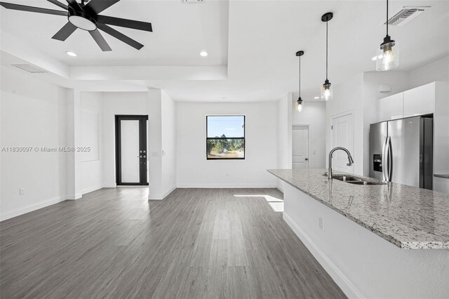 933 Gleason St, Lehigh Acres, FL 33974 - kitchen featuring stainless steel fridge, ceiling fan, dark wood-style floors, white cabinetry, and a raised ceiling