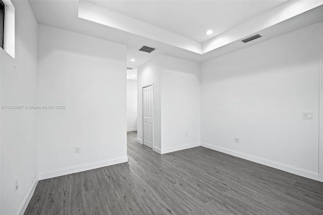 933 Gleason St, Lehigh Acres, FL 33974 - empty room featuring recessed lighting, dark wood finished floors, and a raised ceiling