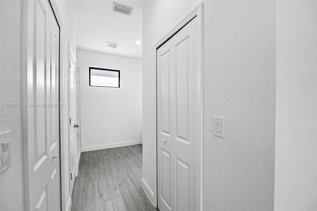 933 Gleason St, Lehigh Acres, FL 33974 - hallway featuring wood finished floors and baseboards