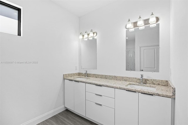 933 Gleason St, Lehigh Acres, FL 33974 - full bathroom featuring double vanity, wood finished floors, and a shower