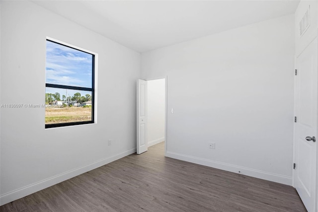 933 Gleason St, Lehigh Acres, FL 33974 - spare room featuring wood finished floors and baseboards
