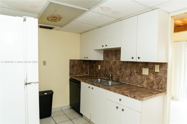 3719 Riverside Dr Unit 3719, Coral Springs, FL 33065 - kitchen with black dishwasher, freestanding refrigerator, dark countertops, decorative backsplash, and light tile patterned floors