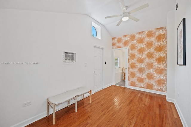 8325 NE 3rd Ave, Miami, FL 33138 - empty room with wallpapered walls, vaulted ceiling, wood finished floors, ceiling fan, and an accent wall