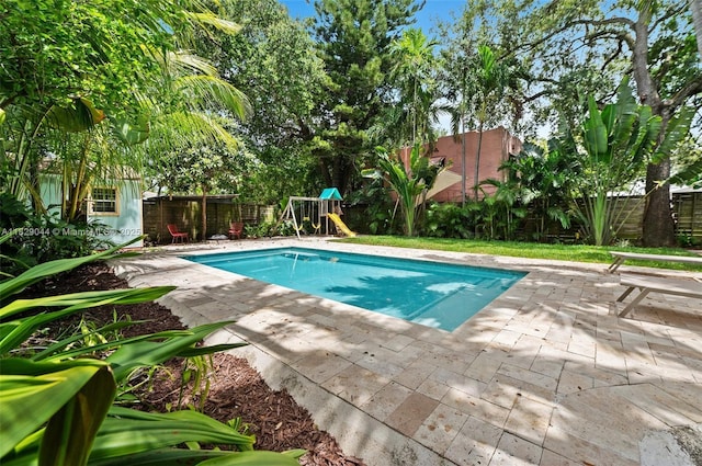 8325 NE 3rd Ave, Miami, FL 33138 - view of pool featuring a fenced backyard, a patio area, and a playground