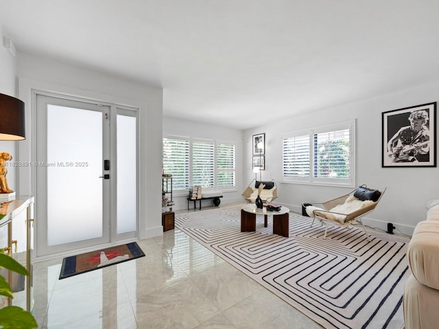 1117 Alberca St, Coral Gables, FL 33134 - living area featuring light marble finish flooring and plenty of natural light