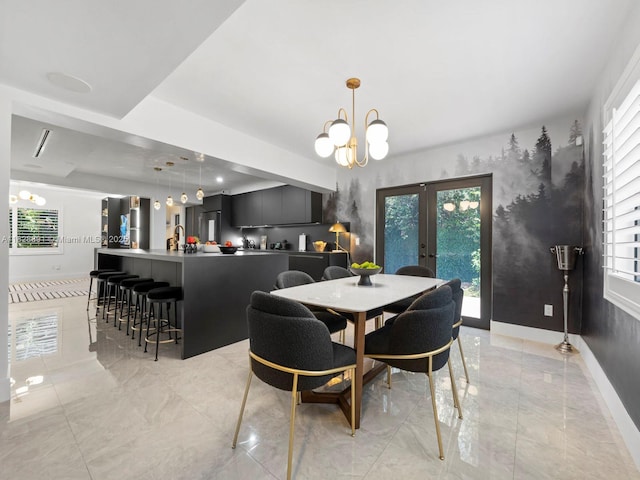 1117 Alberca St, Coral Gables, FL 33134 - dining area with a chandelier, french doors, and light marble finish floors