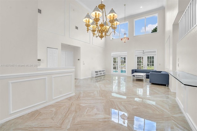 6201 Floridian Cir, Lake Worth, FL 33463 - living room with french doors, a chandelier, plenty of natural light, a high ceiling, and ornamental molding