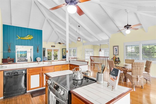 835 70th St, Gulf, Marathon, FL 33050 - kitchen featuring black dishwasher, stainless steel range with electric cooktop, a ceiling fan, and tile counters