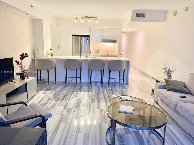 1830 S Ocean Dr Unit 3812, Hallandale Beach, FL 33009 - kitchen featuring stainless steel dishwasher, expansive windows, white cabinetry, light countertops, and modern cabinets
