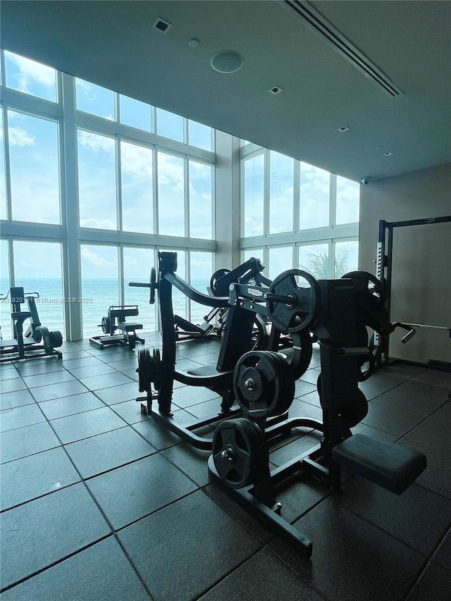 1830 S Ocean Dr Unit 3812, Hallandale Beach, FL 33009 - gym with floor to ceiling windows, healthy amount of natural light, a water view, and a towering ceiling