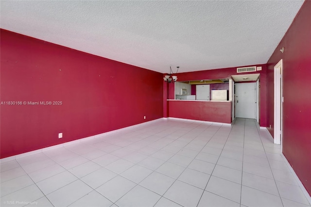 3725 S Ocean Dr Unit 1411, Hollywood, FL 33019 - unfurnished living room featuring a textured ceiling and tile patterned flooring