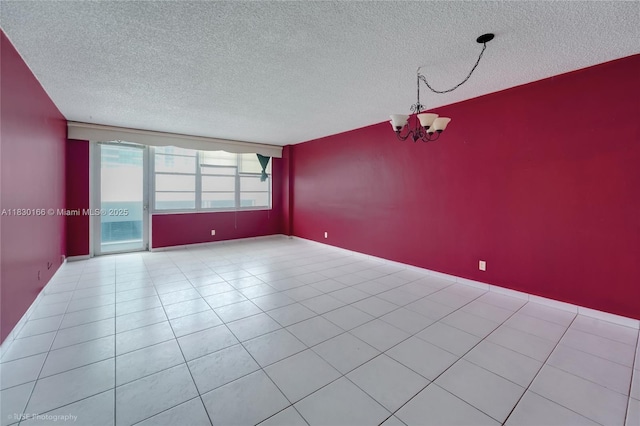 3725 S Ocean Dr Unit 1411, Hollywood, FL 33019 - spare room with a textured ceiling, a chandelier, and tile patterned floors