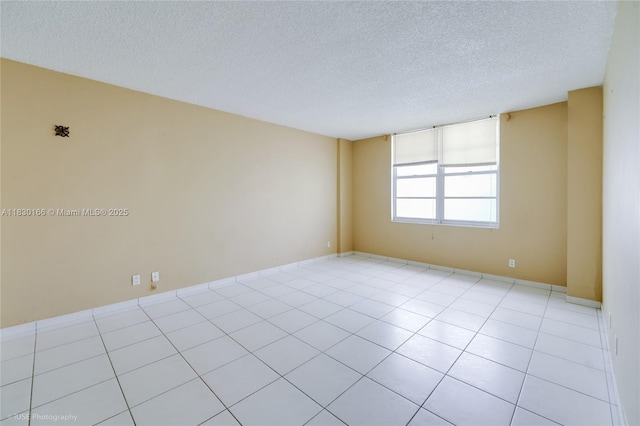 3725 S Ocean Dr Unit 1411, Hollywood, FL 33019 - spare room featuring a textured ceiling and light tile patterned flooring