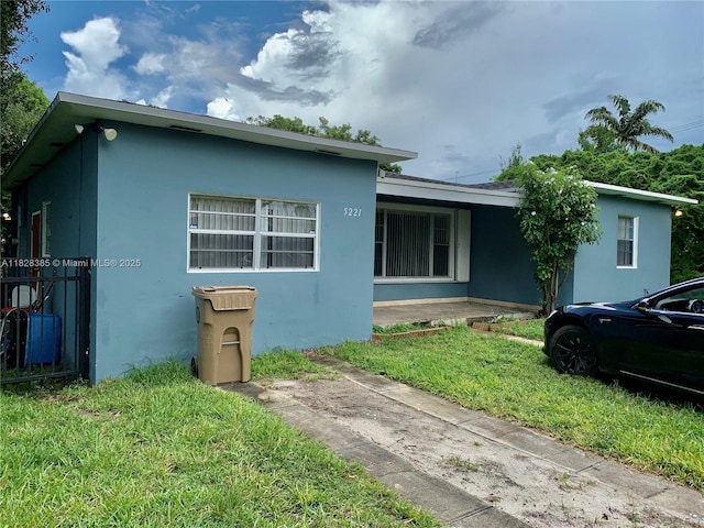5221 Orange Dr, Davie, FL 33314 - view of front facade featuring stucco siding and a front yard