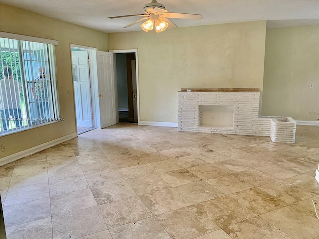 5221 Orange Dr, Davie, FL 33314 - unfurnished living room featuring a ceiling fan and a brick fireplace