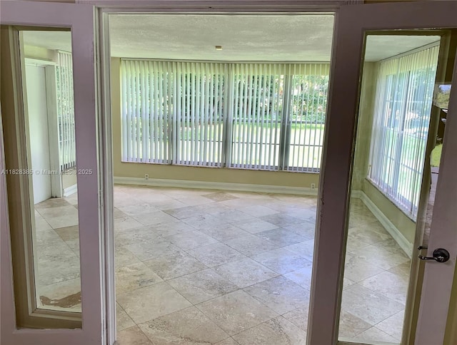 5221 Orange Dr, Davie, FL 33314 - spare room with baseboards and stone tile flooring