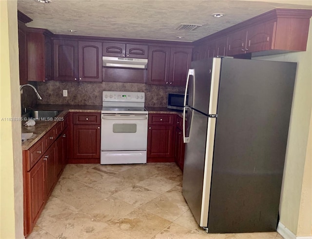 5221 Orange Dr, Davie, FL 33314 - kitchen with appliances with stainless steel finishes, under cabinet range hood, backsplash, and dark countertops