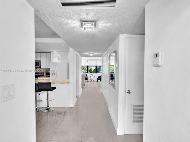 20401 NE 30th Ave Unit 310-8, Aventura, FL 33180 - hall with a textured ceiling and light tile patterned floors